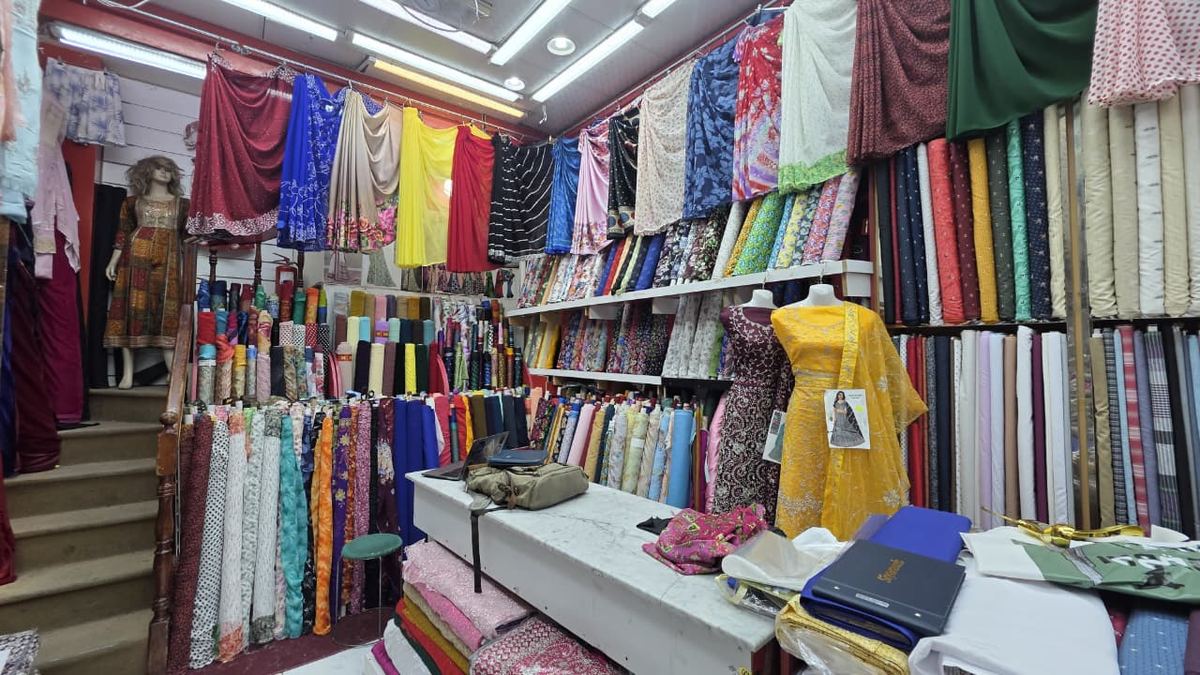 Wall of fabric rolls, sarees and dress material inside Safa Marwa textile shop, Bur Dubai